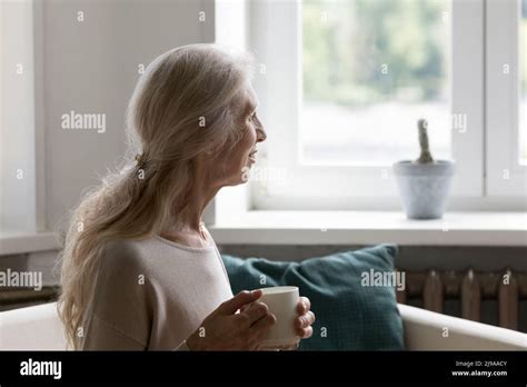 Positive Thoughtful Mature Blonde Lady Enjoying Coffee Break Stock Photo Alamy