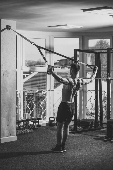 Instructor Of Bodybuilding Man With Nude Torso And Muscular Back In Gym Enjoy Training Trx