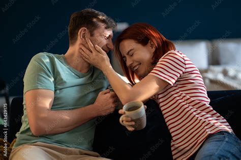 Positive Carefree Middle Aged Couple Laughing Jokingly At Each Other