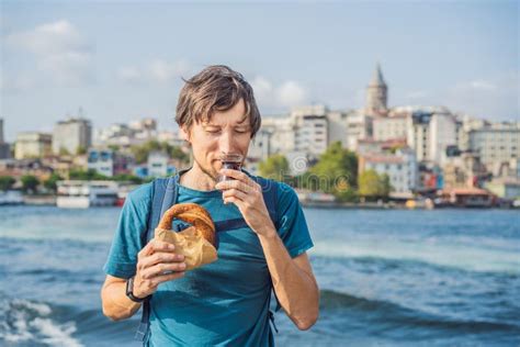 Man In Istanbul Having Breakfast With Simit And A Glass Of Turkish Tea