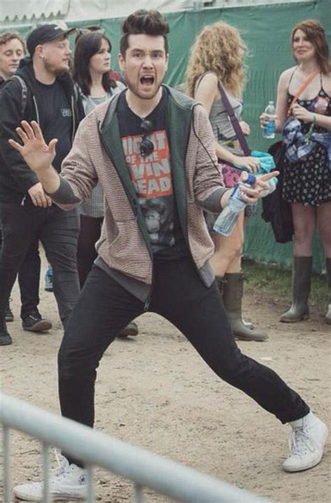 A Man With His Mouth Wide Open Standing In Front Of A Group Of People