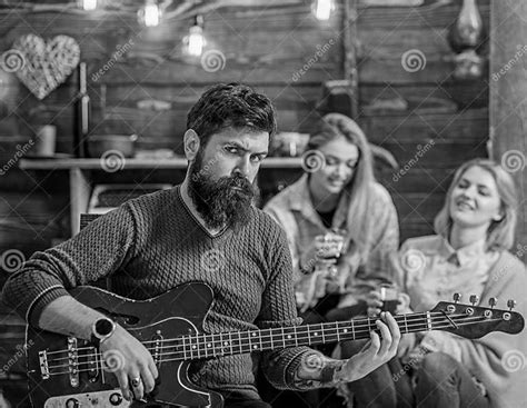 Rock Musician With Long Beard And Tattooed Arm Playing Guitar Bearded