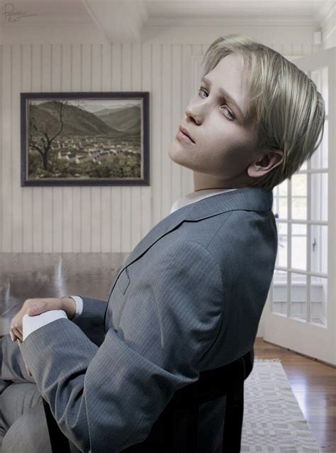 A Man In A Suit Sitting On A Couch With His Arms Crossed And Looking