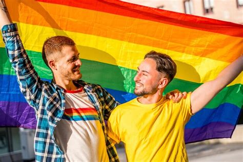 Premium Photo Portrait Of Gay Male Couple With Rainbow Flag At Pride