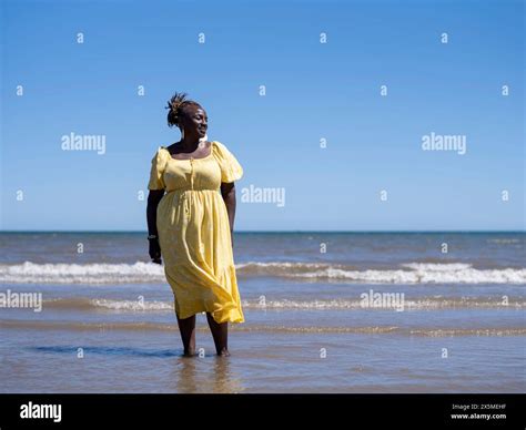 Mature Woman Standing On Beach Stock Photo Alamy