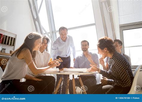 Cheerful Diverse Team People Laughing At Joke Eating Pizza Toget Stock