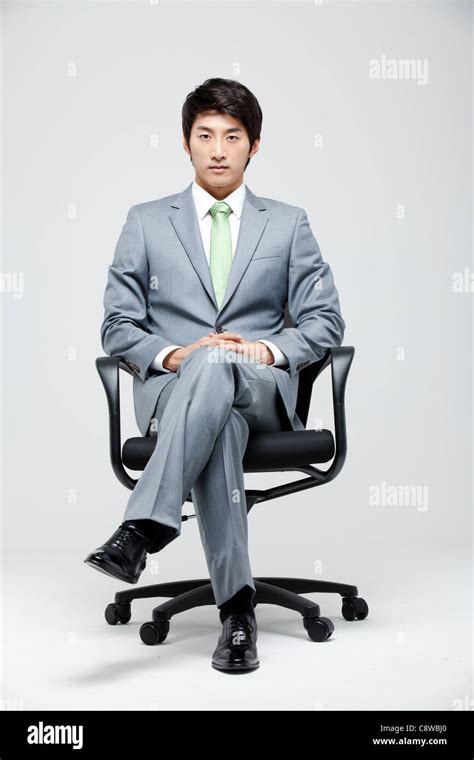 Asian Businessman Sitting On Chair With Leg Crossed Stock Photo Alamy