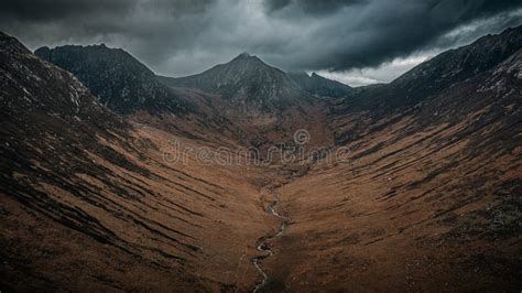 Mountain Landscape With A Dark Cloud Creating A Stunning Shadow In