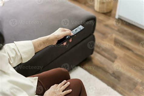 Elderly Woman Watching Smart Tv And Using Remote Controller Hand