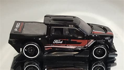 Машинка Базова Hot Wheels Ford F 150 Lightning Custom Green Speed 1 64 HTD01 Black купити в