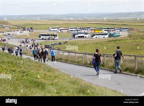 Tour Buses Parked And Tourists At The Cliffs Of Moher Experience Stock