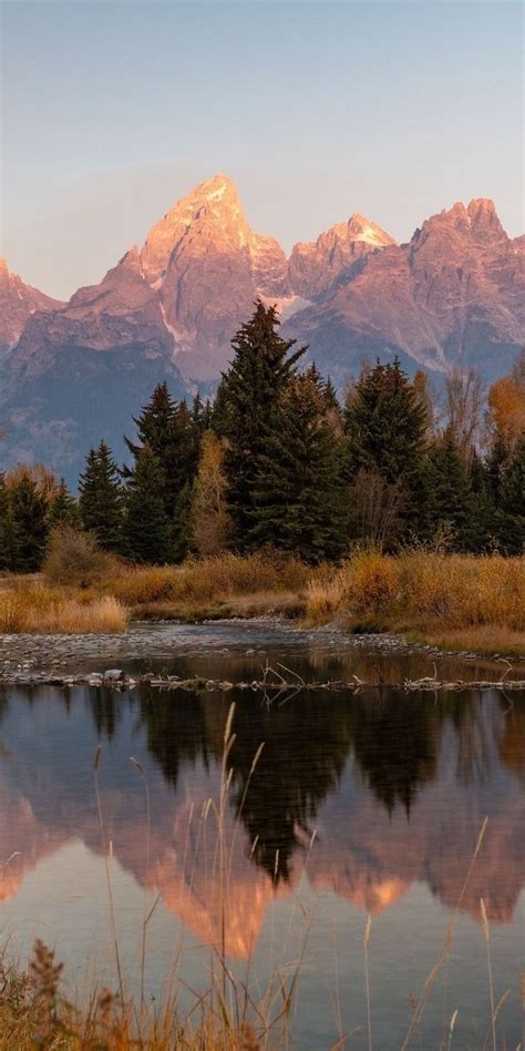 The Mountains Are Reflected In The Still Water Of This Lake As The Sun