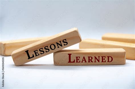 lessons learned text  wooden blocks  white cover background