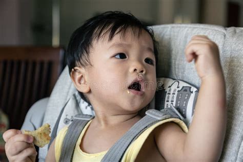 Adorable Joyful And Happy 1years Old Chinese Baby Boy Having Food While