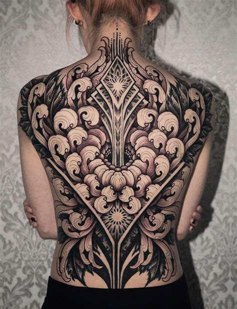 The Back Of A Woman S Body Is Covered In Intricate Tattoos