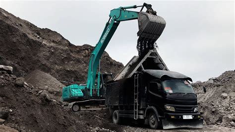 Kobelco SK200 Excavator Loading Rocky Sand Into Trucks Non Stop Daily