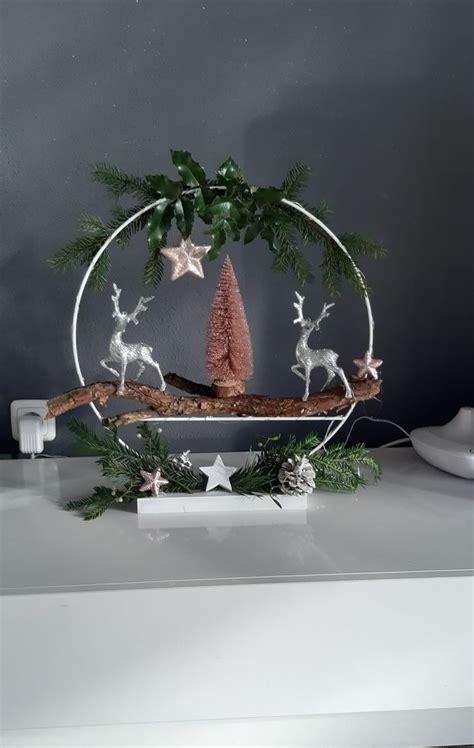 A Christmas Decoration With Deers And Trees