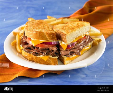 Roast Beef Sandwich With Tomato And Cheese On Grilled Sourdough Bread