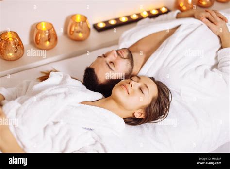 Man And Woman Lying Down On Massage Beds At Luxury Spa And Wellness