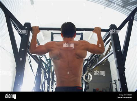 Man Doing Pull Ups In Gym Stock Photo Alamy