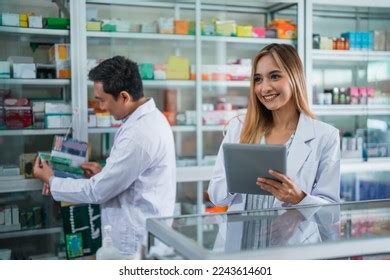 Asian Female Pharmacist Uniform Working Using Stock Photo 2243614801 ...