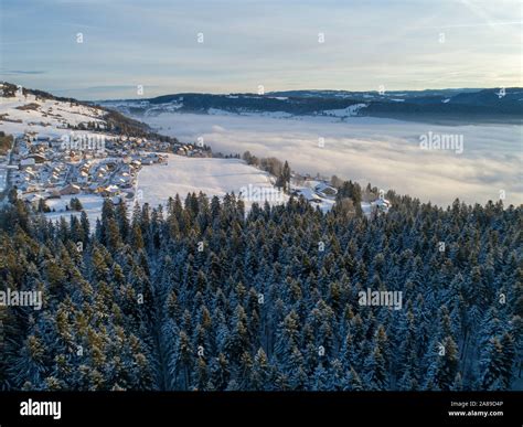 Aerial view of Morteau in winter, in the Jura mountain range. Forest ...