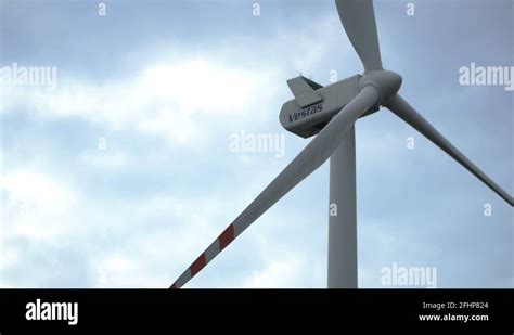 Vestas Industrial Wind Turbine Spinning Against A Bright Cloudy Sky In