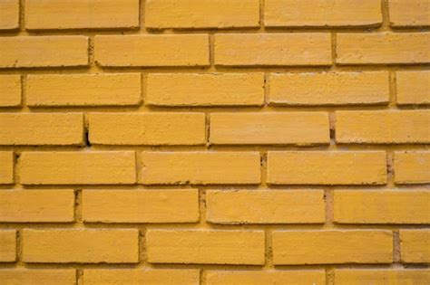 Premium Photo | Yellow brick wall texture