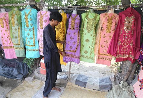 Roadside vendors displaying the ladies suits to attraction the customers at Tando Yosuf Road.