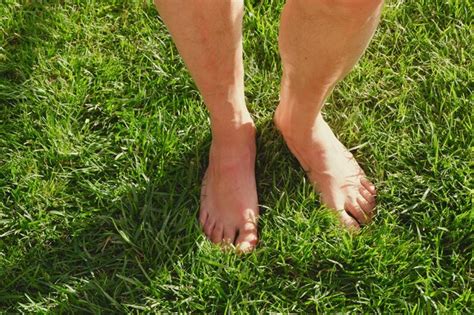 Premium Photo Naked Male Feet Standing On The Vivid Green Grass Conceptual For Foot Health And