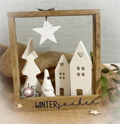 A Wooden Frame With Christmas Decorations In It And A White Star