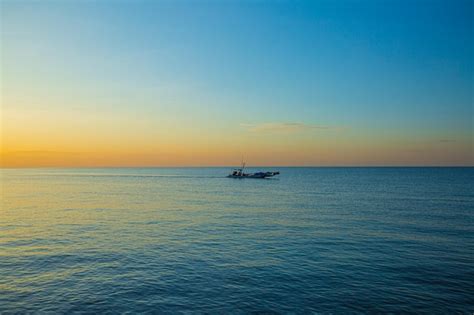 Premium Photo Sea And Small Fishing Boats In The Morning A Small