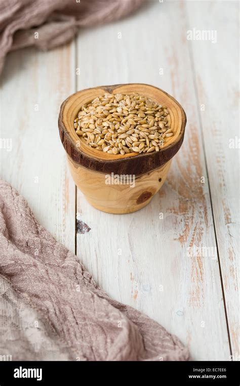 Bowl Of Einkorn Wheat Triticum Monococcum On Light Wood Stock Photo