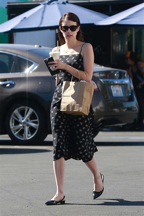 Emma Roberts Wears A Floral Print Black Dress As She Steps Out To Grab