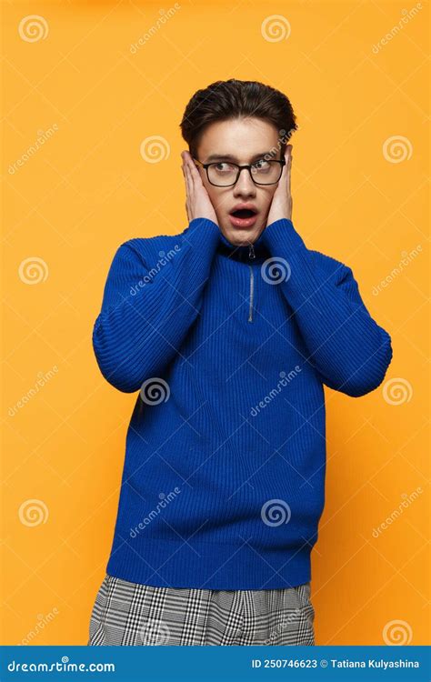 A Funny Shocked Man Stands In Glasses A Blue Zip Up Jacket And