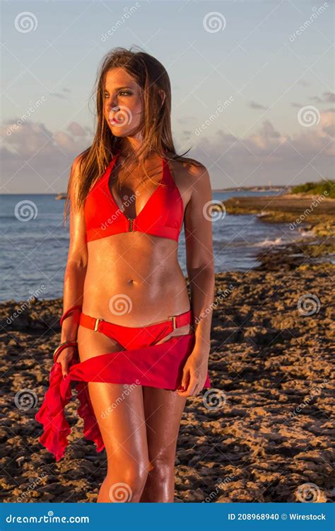 Vertical Shot Of A Beautiful Woman Wearing A Pink Bikini At The Beach