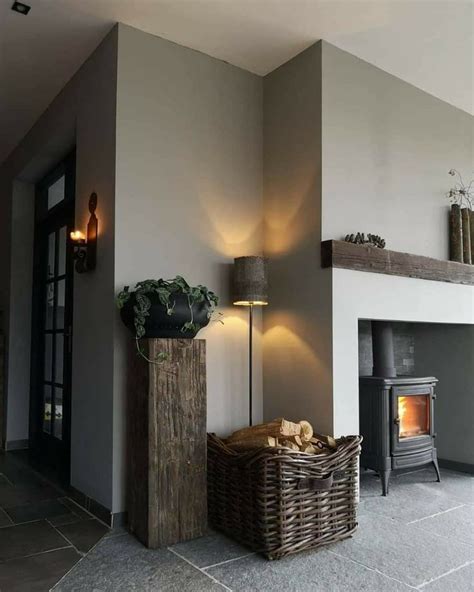 A Living Room With A Fire Place Next To A Lamp And A Basket On The Floor