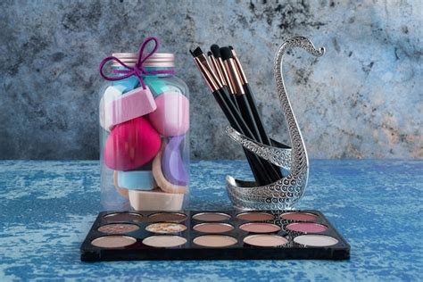 Premium Photo Nude Eyeshadow Palette Sponges And Brushes On Marble Surface