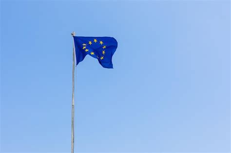 Premium Photo European Union Eu Flag Is Flying On Blue Sky Background