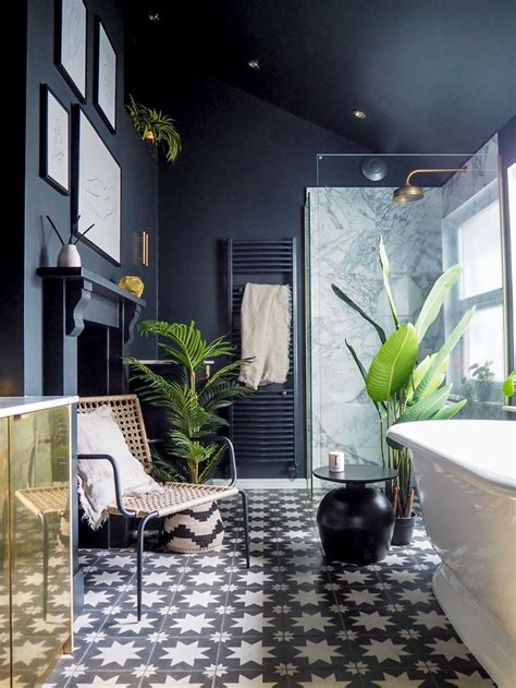 A Bath Room With A Tub A Chair And A Plant On The Floor In It