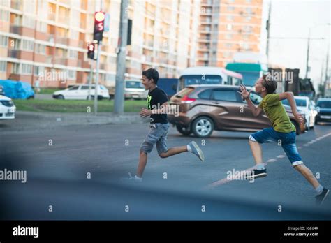 Children Run Across The Road Stock Photo Alamy