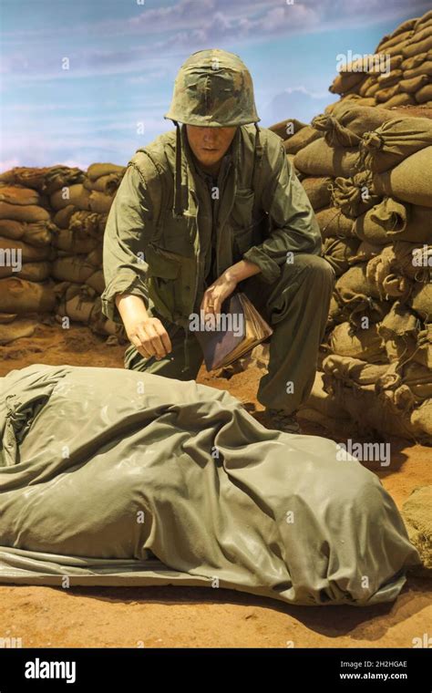 A Chaplain Priest With A Bible Delivers A Prayer To A Dead Soldier In