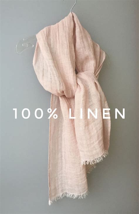 The 100 Linen Scarf Is Hanging On A Hanger