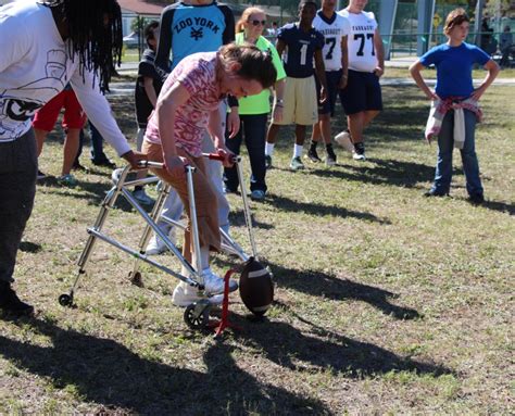 Drill And Football Teams Give Back At Nina Harris Center For