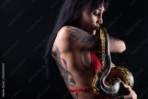 Photo Of Brunette Woman Kissing Snake In Red Lingerie On Dark Background Stock Photo Adobe Stock