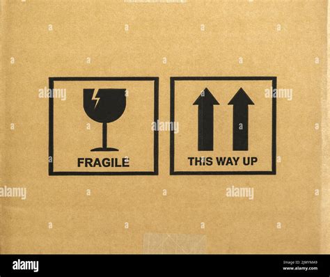 Cardboard box with the words Fragile and This Way Up, along with ...