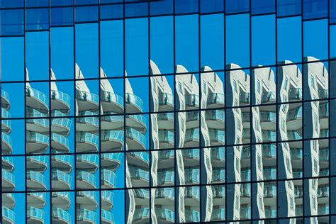 Reflection in a Modern Glass Building · Free Stock Photo