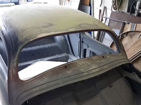 An Old Car Is Being Worked On In A Garage