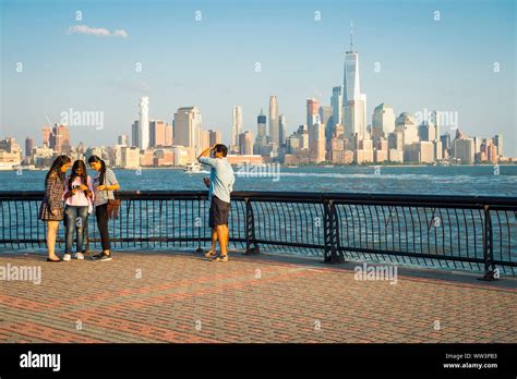 HOBOKEN, NJ, USA - AUGUST 15, 2017: Visitors walk the waterfront ...