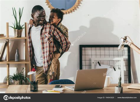 Happy father and son in office Stock Photo by ©ArturVerkhovetskiy 164043520